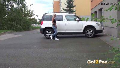 Naughty teen pissing in public while car is left locked - sexu.com